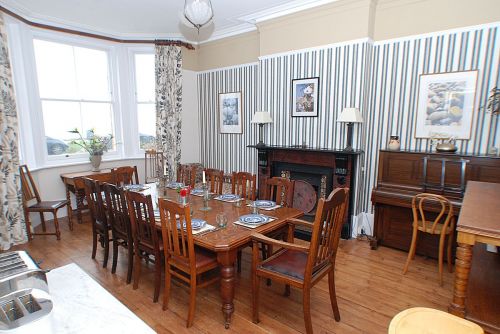 The dining room has great sea views and glorious morning sunshine.  The large table comfortably seats 12.