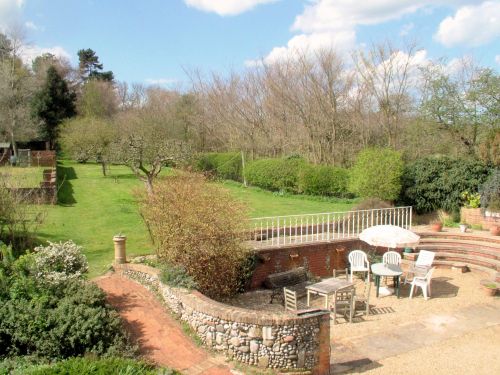 The garden is large with a mixture of lawns, shrubs, sitting areas and outbuildings. This view is taken from the roof terrace on the first floor.