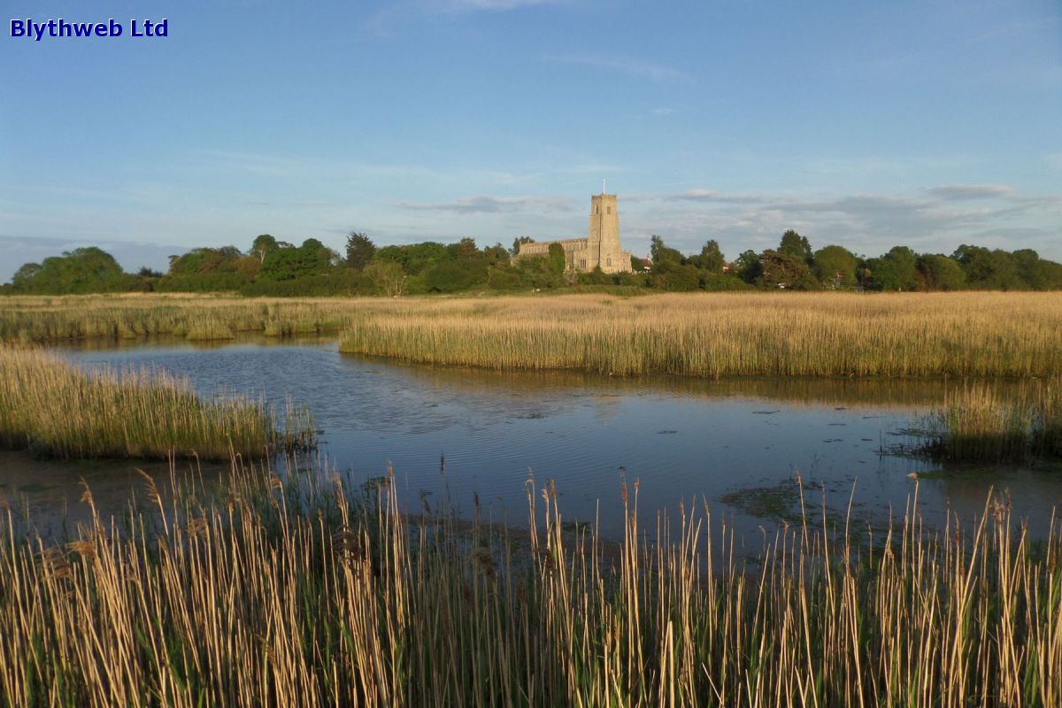 Blythburgh Holy Trinity Church (The Cathedral of the Marshes) across the River Blyth reedbeds