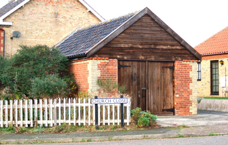 At the entrance to Church close is a stylish old garage built by the Henham Estate